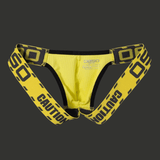 Jockstrap taille basse jaune et noir avec bandes élastiques larges, lingerie masculine graphique inspirée de l’univers gay